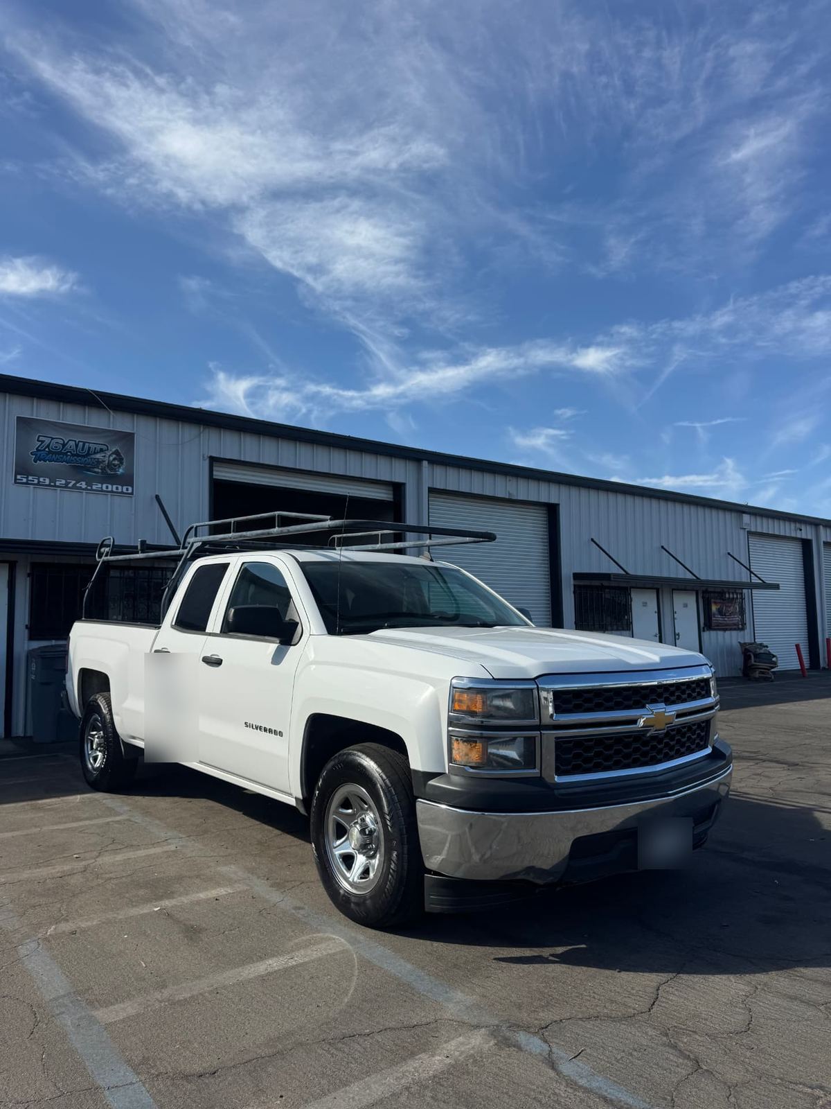 Chevrolet Silverado parked outside the 76Auto shop, marked with the 76Auto sign